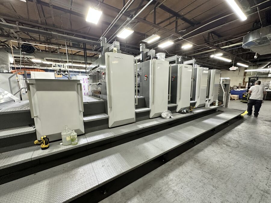 A pressman at work beside the multi-colour Komori press on the Nova Printing floor