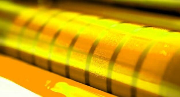 Gold ink drawn out across a press roller